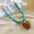 Bohemian gold chain necklace with blue turquoise beads and a natural shell pendant - Blue Conch Style