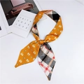 Close-up of double-sided skinny scarf with yellow cat print and classic plaid pattern - Yellow