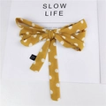 Foulard per capelli giallo a pois bianchi con fiocco grande su sfondo di rivista - Giallo a Pois