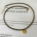 Handmade black beaded necklace with gold circular floral pendant and adjustable chain - Mirror Finish Round Rose