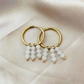 Elegant gold drop earrings featuring three vertical strands of white pearls on round hoops - White