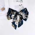 Detailed flat lay of a blue satin scarf with vintage gold chain prints and ribbon knot - Dark Green Metal Chain