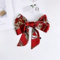 Detail of red satin bow headband with vintage chain pattern and quality labels - Red Metal Chain
