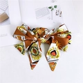 Detail of a large satin bow with poker card, heart, and tiger prints in vintage style - Heart Label Yellow