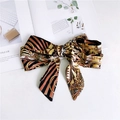 Detail of a satin silk scarf bow with vintage baroque patterns and leopard print accents - Retro Kumquat