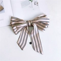 Detail of pink striped 100% polyester narrow silk scarf with bow tie and laundry label - Striped Pink