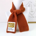 Caramel orange chunky knit scarf with GOOD LUCK letter patch on white mannequin - Orange Red