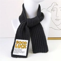 Black ribbed knit scarf for winter featuring a Good Luck text label and thick texture - Black
