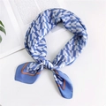 Blue and white geometric silk scarf with orange border in elegant lifestyle setting - Blue V Letter