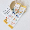 White sun protection sleeves with yellow trim featuring cute milk tea and sun illustrations - Mesh Milk Tea
