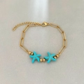 Bracciale a catena a graffetta dorata con due ciondoli a stella marina turchese - Stile Stella Marina