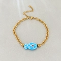 Gold stainless steel link bracelet with blue ceramic fish charm and evil eye detail - Blue