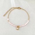 Minimalist gold beaded bracelet featuring pink opals and a sparkling star charm - Pink