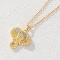 Gros plan d'un pendentif éléphant doré serti de zircons sur une surface texturée - Style Tête d'Éléphant Texturée Dorée (E)