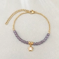 Bracciale di perle in acciaio inox con pietre occhio di gatto viola e ciondolo a stella - Violetto