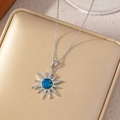Titanium steel starburst necklace with blue star zircon pendant on a gold jewelry box - Sixteen-pointed Star Burst Style / Silver
