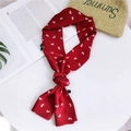 Red narrow silk scarf with white heart pattern tied in a knot on a desk setup - 7 Red Heart