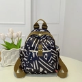 Navy blue oxford backpack with white geometric stripes and khaki straps on a white table - Black & White Stripes