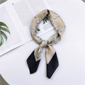 Elegant champagne and black zebra print silk scarf tied in a stylish knot on table - Small Zebra Khaki Black