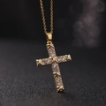 Macro shot of gold cross pendant with clear crystals over a dark bokeh background - Bamboo Frame Style (Style D)