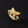 Macro shot of golden butterfly ring featuring zircon pavé wings and pearl chain band - Gold Butterfly Chain Pearl Style (E)