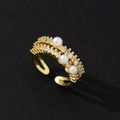 Macro shot of gold adjustable bow ring with sparkling zircons and three elegant pearls - Gold Row Zirconia Three Pearl Style (G)