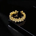 Detail of gold floral open ring with zircon micro-pave on glossy black surface - Floral Open Ring / Gold