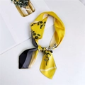 Bright yellow floral silk scarf with black pine needles and stripe detail tied in a knot - Magnolia Striped Yellow