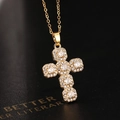 Gold-plated cross necklace with white sparkling zircons on black leather background - Gold Cluster Cross (V)