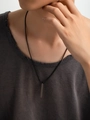 Detail of a minimalist black vertical bar pendant on a box chain worn by a male model - 18K Gold / Black