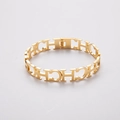 Bracciale rigido in acciaio inossidabile dorato con motivo CH traforato e molla - Oro