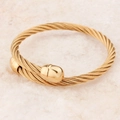 Polished gold twisted cable stainless steel cuff bracelet in a minimalist punk style - Gold
