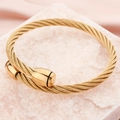 Golden cable-style twisted stainless steel open cuff bracelet with black ring accent - Gold