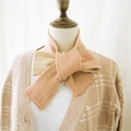 Pink and khaki striped knit scarf with a cross-knot bow design on a wooden mannequin - Pink