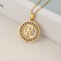Gold plated stainless steel necklace featuring a crystal paved round letter R pendant - Letter R