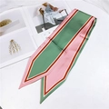 Detail of satin twilly scarf with pink and green stripes draped on a white surface - 86cm / Border Green Pink