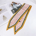Close-up of narrow satin scarf with floral pattern and 100% polyester wash label - 86cm / Floral Beige Orange