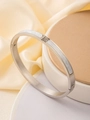 Detailed macro view of silver brushed steel bangle with white shell inlay and zircon accents - Silver
