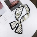 Elegant narrow twilly scarf with black polka dots on cream silk, tied in a bow - White with Polka Dots