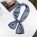 Elegant blue twilly scarf with white polka dots and orange border in a knot style - Blue with Polka Dots