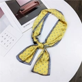 Yellow silk necktie with blue polka dots tied in a bow on a white round table - Yellow Tiny Dot