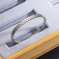 Silver mesh titanium steel bracelet with chain link texture on a luxury jewelry tray - Steel
