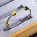 Minimalist twisted cable steel bracelet with three polished 18k gold-plated metal discs - Two-tone (Gold & Silver)