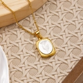 Golden rectangular floral relief pendant necklace with white daisy motif inlay - April