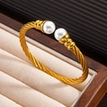 Adjustable 18k gold plated cable twist bracelet featuring two elegant white pearls - Gold Color Bracelet