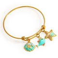 Verstelbare gouden oceaanarmband met hangers van een zeester, schelp en kleine vis - Goud