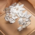 Silver hollow rose flower cuff bracelet with intricate floral relief design - Steel