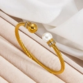 Twisted cable cuff bracelet in 18k gold finish featuring white pearl and gold bead accents - Twisted Pearl and Gold Ball Style (szgss138) / Gold