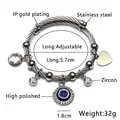 Verstellbares Drahtarmband mit blauem Evil Eye Anhänger und Zirkon-Herz-Detail, 5.7cm - Stahlfarbe