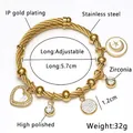 Detail of adjustable gold wire bracelet with heart, moon, and star zircon charms - Gold